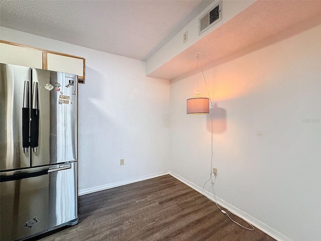 kitchen featuring dark wood-type flooring and stainless steel fridge