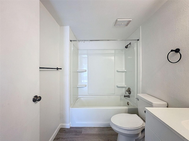 full bathroom featuring shower / tub combination, hardwood / wood-style floors, vanity, toilet, and a textured ceiling