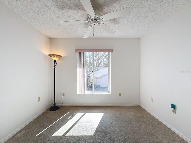 carpeted empty room with ceiling fan and a textured ceiling