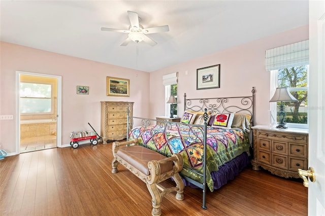 bedroom featuring connected bathroom, hardwood / wood-style flooring, and ceiling fan