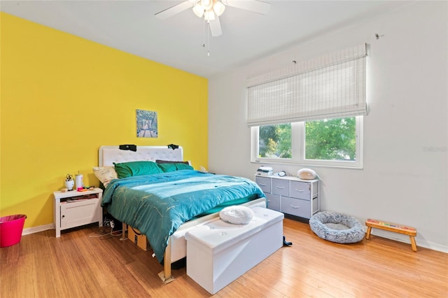 bedroom with light hardwood / wood-style floors and ceiling fan