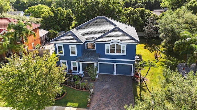 view of front of house featuring a garage and a front lawn