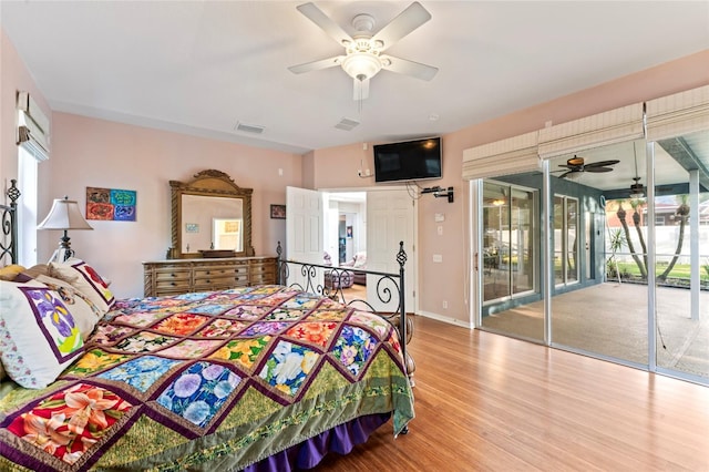 bedroom with ceiling fan, wood-type flooring, and access to exterior