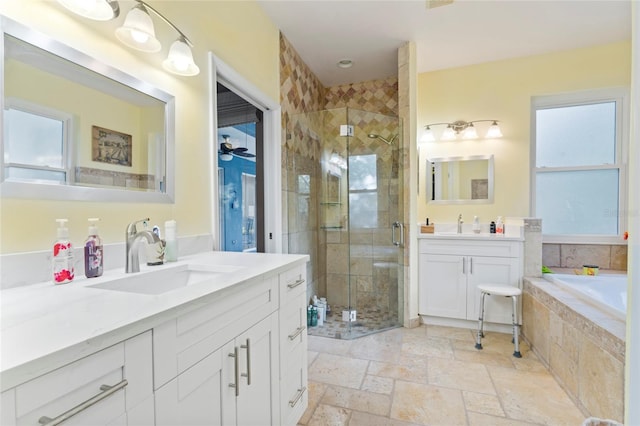 bathroom featuring vanity, independent shower and bath, and ceiling fan