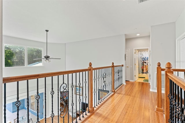 corridor with hardwood / wood-style flooring