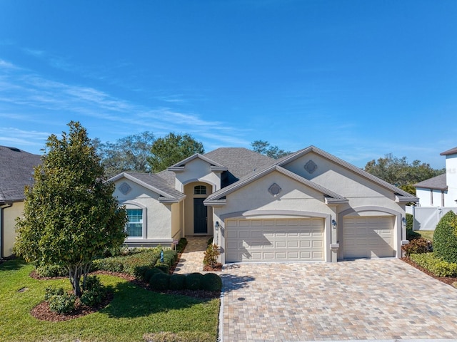 view of front of property featuring a garage and a front lawn