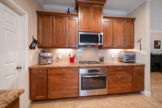 kitchen featuring light stone counters, backsplash, crown molding, and stainless steel appliances