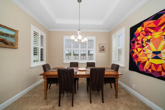 tiled dining space featuring a raised ceiling, ornamental molding, and an inviting chandelier