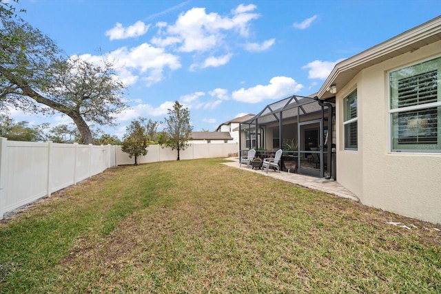 view of yard with a lanai and a patio