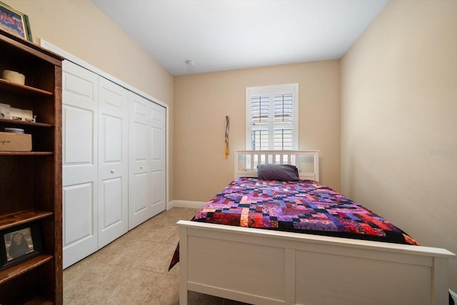 tiled bedroom featuring a closet