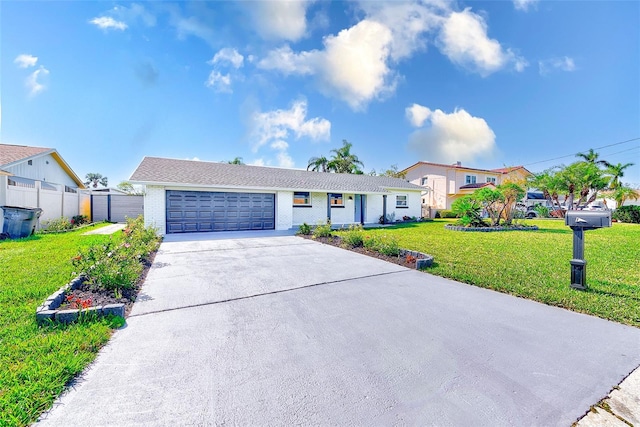 ranch-style house featuring brick siding, concrete driveway, an attached garage, fence, and a front lawn