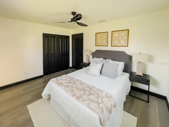 bedroom with a ceiling fan, baseboards, and wood finished floors