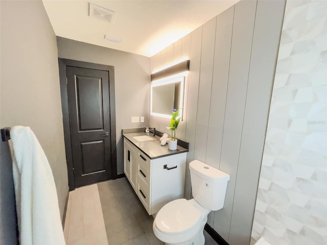 bathroom with visible vents, vanity, and toilet