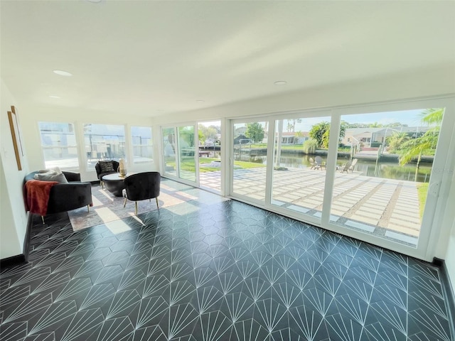 unfurnished sunroom with a water view