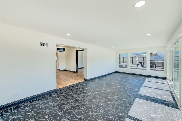 empty room with baseboards, visible vents, a wealth of natural light, and recessed lighting