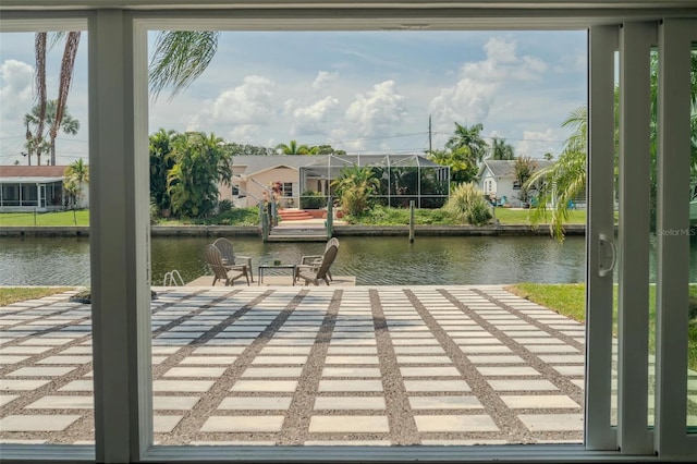 view of dock with a residential view and a water view