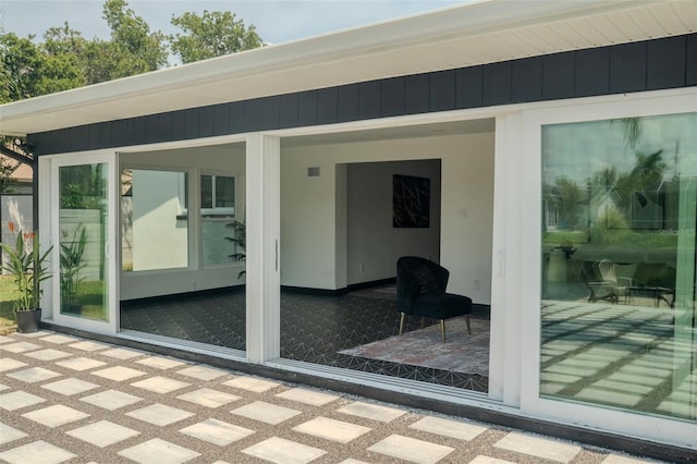 doorway to property with a patio