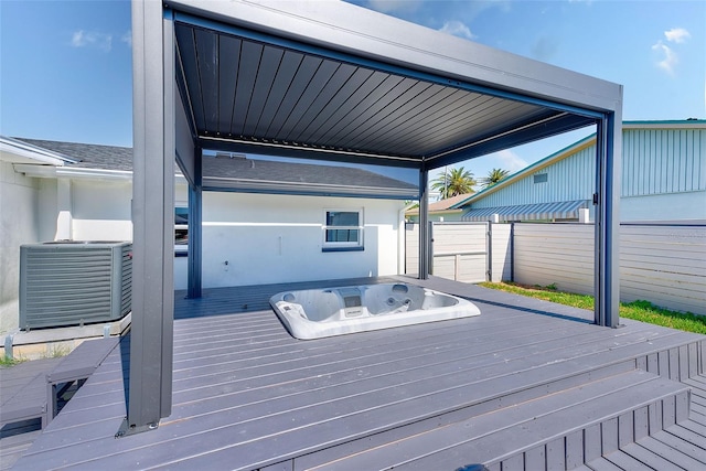 wooden deck featuring fence and hot tub deck surround