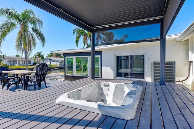 wooden terrace with hot tub deck surround and outdoor dining space