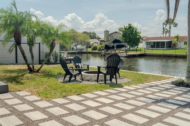 view of home's community with an outdoor fire pit, a water view, a yard, a boat dock, and a residential view