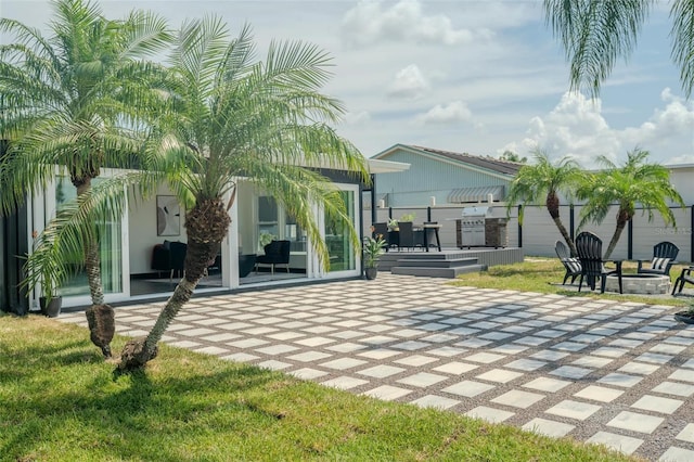 back of house featuring an outdoor fire pit and a patio