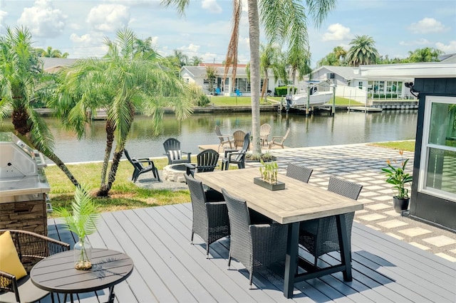 view of dock featuring an outdoor fire pit, outdoor dining area, and a deck with water view