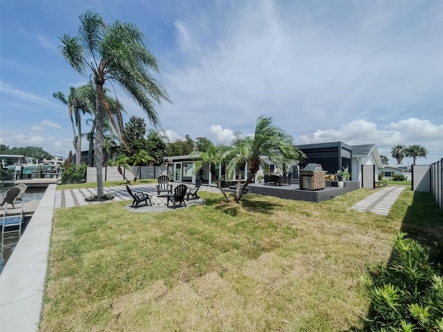 view of yard featuring fence and a boat dock