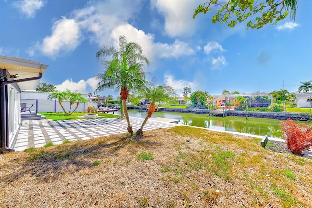 view of yard featuring a residential view and a water view