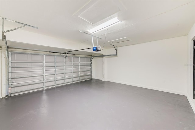 garage featuring a garage door opener and baseboards