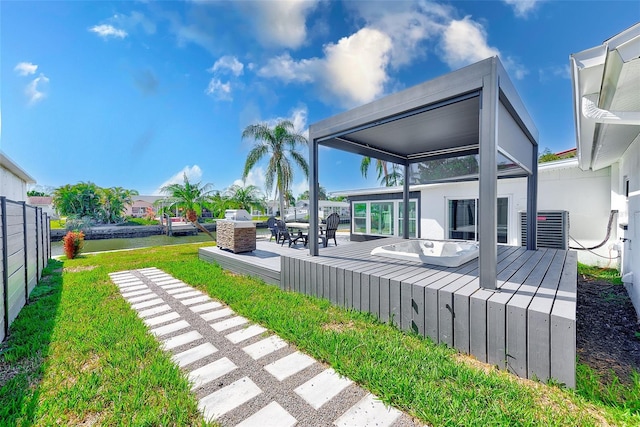 view of yard featuring a deck, central AC unit, outdoor dining area, and fence