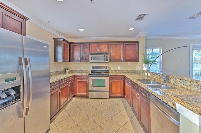 kitchen with sink, light tile patterned floors, light stone counters, kitchen peninsula, and stainless steel appliances