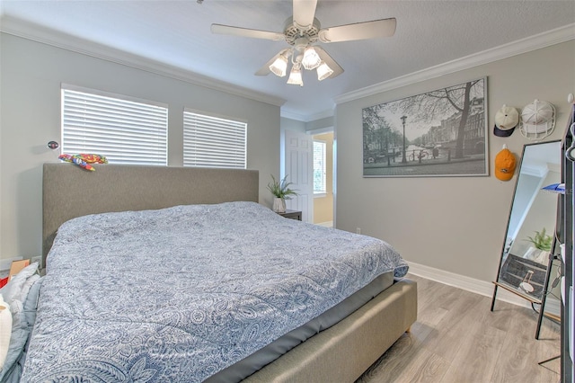 bedroom featuring ceiling fan, ornamental molding, and light hardwood / wood-style flooring