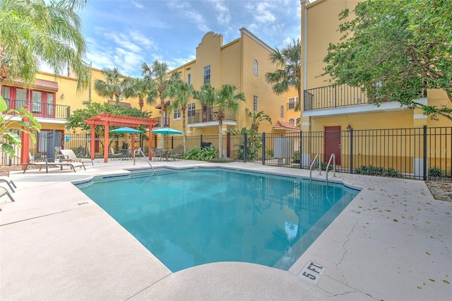 view of swimming pool featuring a pergola and a patio