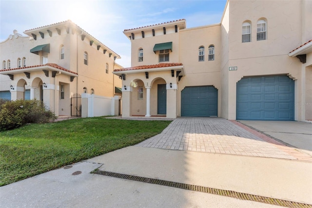 mediterranean / spanish home with a garage and a front yard