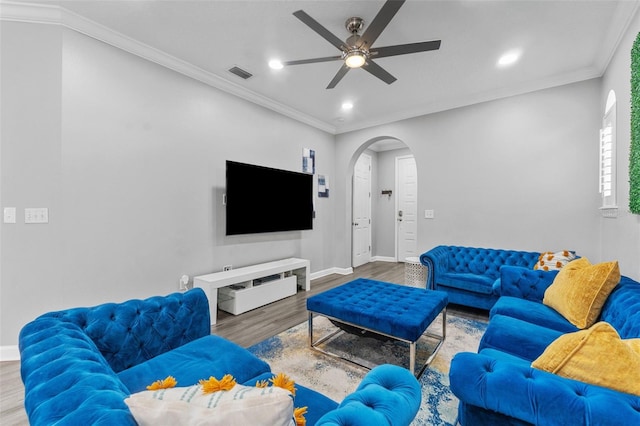 living room with crown molding, hardwood / wood-style floors, and ceiling fan