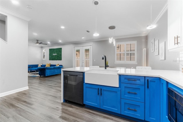 kitchen featuring french doors, blue cabinets, sink, hanging light fixtures, and stainless steel dishwasher