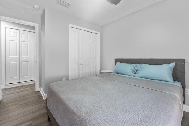 bedroom featuring dark hardwood / wood-style flooring, a closet, and ceiling fan