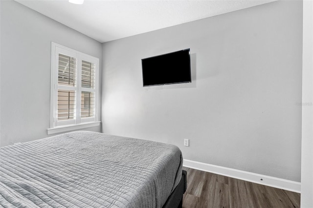 bedroom featuring dark hardwood / wood-style flooring