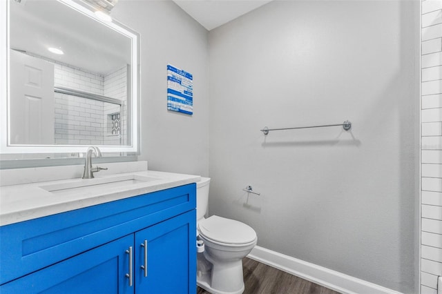 bathroom featuring an enclosed shower, vanity, hardwood / wood-style flooring, and toilet