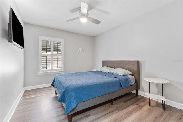 bedroom with ceiling fan and light hardwood / wood-style floors