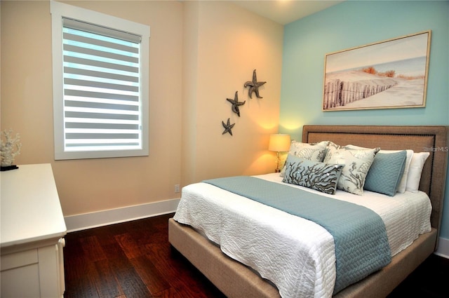 bedroom with dark wood-type flooring