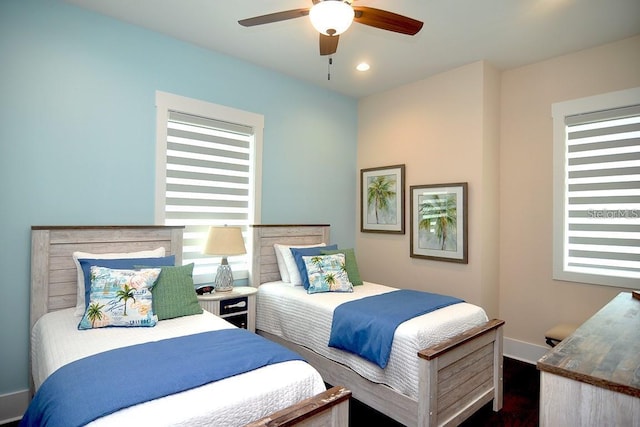 bedroom with dark hardwood / wood-style floors and ceiling fan