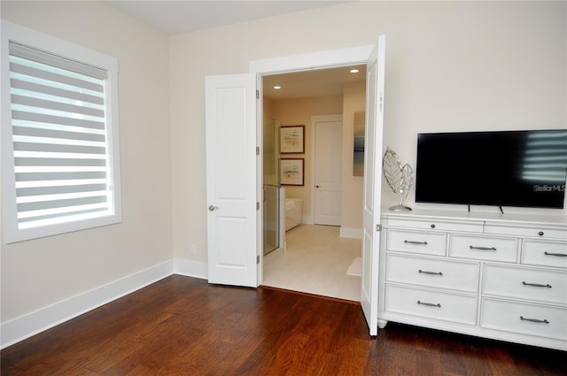 unfurnished bedroom with dark hardwood / wood-style floors