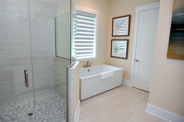 bathroom featuring shower with separate bathtub