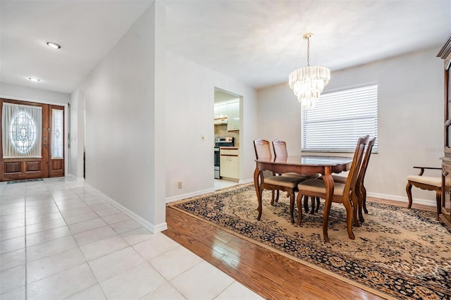 dining space with a wealth of natural light, a chandelier, and light wood-type flooring