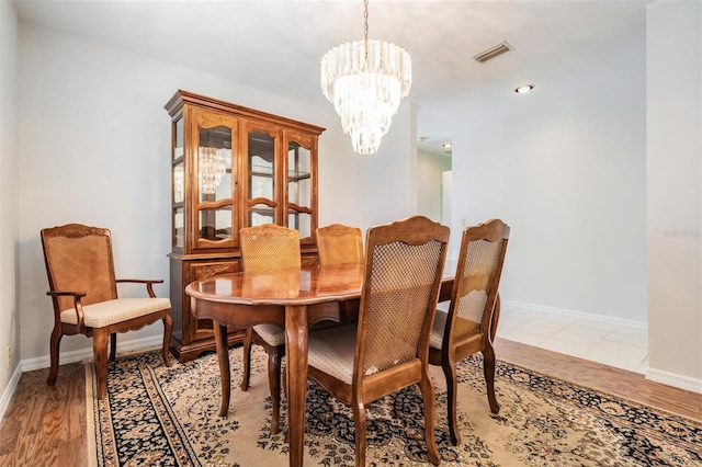 dining area featuring a chandelier and light hardwood / wood-style floors