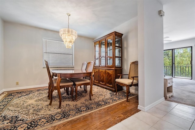 tiled dining area with an inviting chandelier