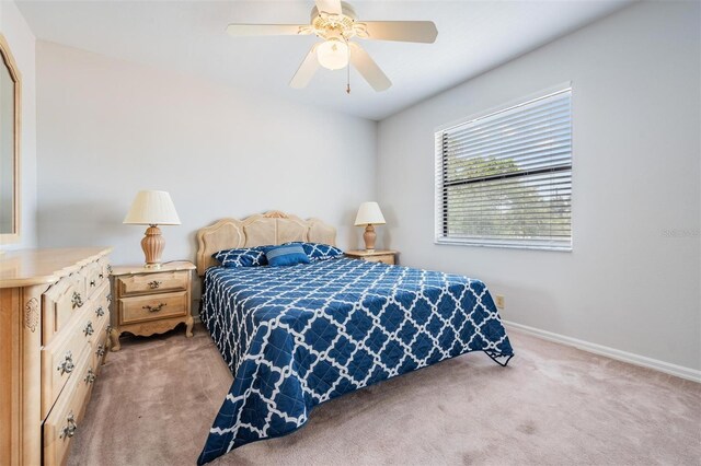 bedroom featuring light carpet and ceiling fan