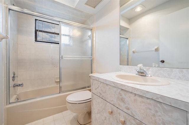 full bathroom with toilet, vanity, shower / bath combination with glass door, and tile patterned flooring