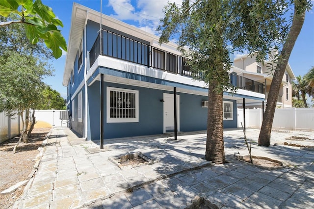 rear view of house featuring a balcony